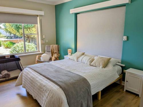 a bedroom with a large bed with a large window at Holli-daze on Coast Moonta Bay in Port Moonta