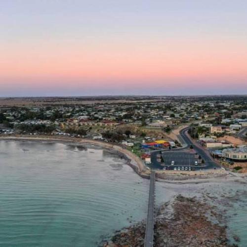 an aerial view of a city and the ocean at Holli-daze on Coast Moonta Bay in Port Moonta