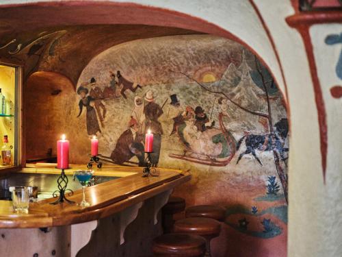 a room with a wall with a painting on it at Hotel Chesa Grischuna in Klosters
