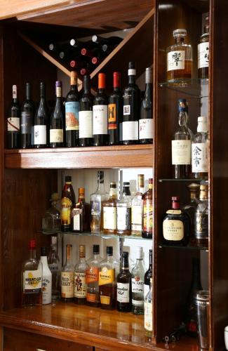 a shelf filled with lots of bottles of alcohol at Snowlines Lodge Hakuba in Hakuba