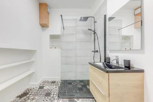 La salle de bains est pourvue d'un lavabo et d'une douche. dans l'établissement Le White Cozy - Lyon - Croix Rousse, à Lyon