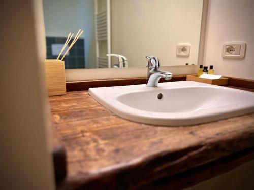 a bathroom with a white sink and a mirror at Casale Solindio in La Pieve