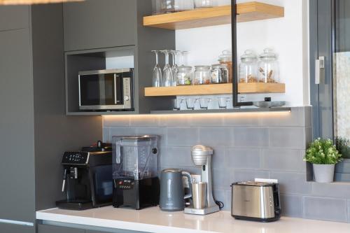 a kitchen counter with a blender on a counter top at Song of the Sea in Sivota