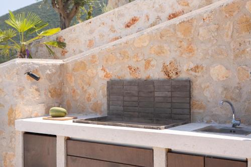 a kitchen with a sink and a counter top at Song of the Sea in Sivota
