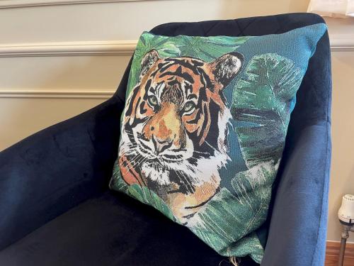 a pillow with a tiger on it sitting on a couch at Pass the Keys Spectacular 7BR House Hot Tub and Gardens in Gretna in Gretna Green