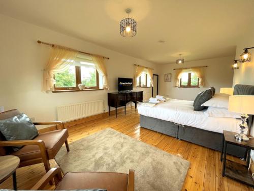 a bedroom with a bed and a desk in it at Pass the Keys Spectacular 7BR House Hot Tub and Gardens in Gretna in Gretna Green