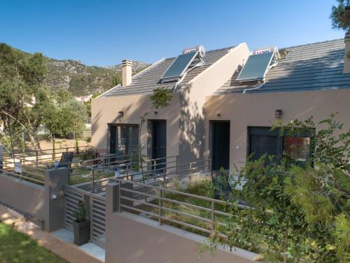 a house with solar panels on the roof at Osiris - cozy sea walk lodge with private garden in Nea Makri