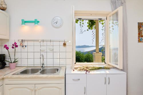 a kitchen with a sink and a window at House Lilla in Brsečine