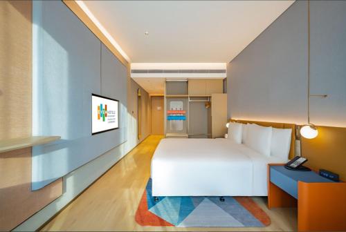 Ένα ή περισσότερα κρεβάτια σε δωμάτιο στο EVEN Hotels Shanghai Expo by IHG