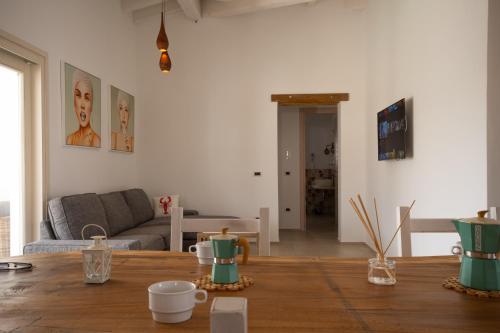a living room with a table and a couch at Capannizza Villas in Budoni