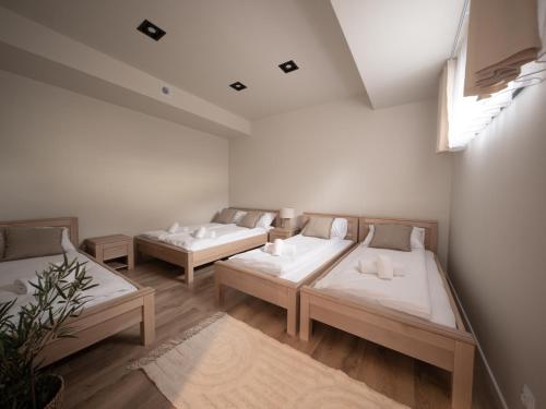 a room with three beds and a window at Sweet Dreams Apartment in Zator