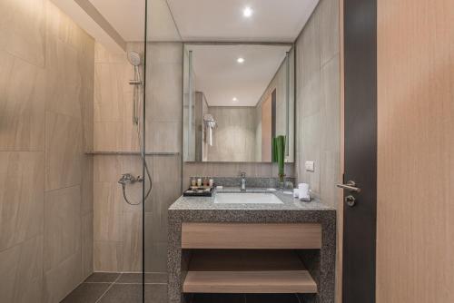 a bathroom with a sink and a shower at Seda Central Bloc Cebu in Cebu City
