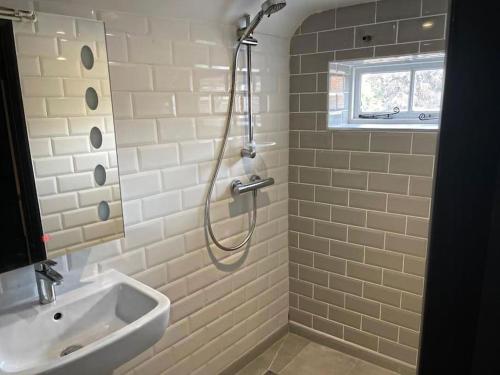 a bathroom with a shower and a sink at SmithStayz Apartments Epping in Epping