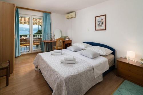 ein Hotelzimmer mit einem Bett und einem Balkon in der Unterkunft Apartments with a parking space Stanici, Omis - 2819 in Omiš