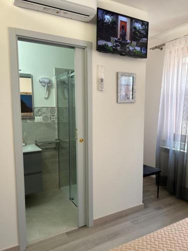 a bathroom with a shower and a glass door at Dolce Dormire in Castiglione del Lago