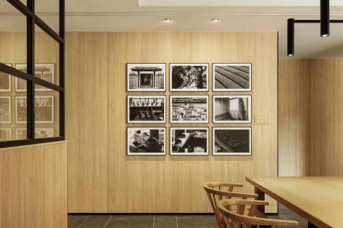 a dining room with pictures on the wall at Fairfield by Marriott Saga Ureshino Onsen in Ureshino