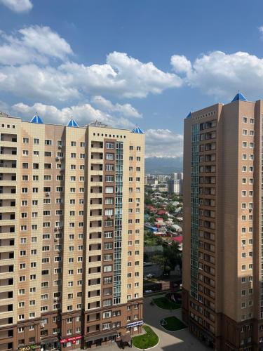 a view of some tall buildings in a city at Отличные апартаменты со всеми удобствами in Almaty