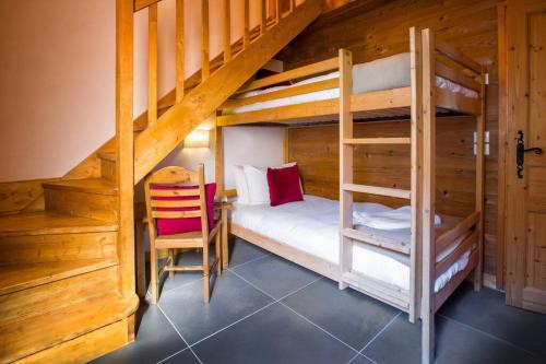 - une chambre avec 2 lits superposés et une chaise dans l'établissement Toulouse - 3 bedroom apt close to the slopes with log fire, à Sainte-Foy-Tarentaise