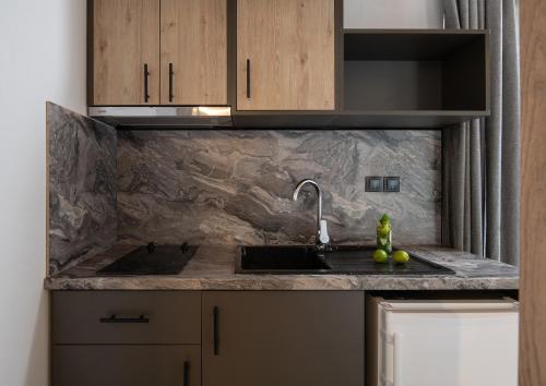 a kitchen with a sink and a counter top at Erifili at Sarti Beach Apartments & Studios in Sarti