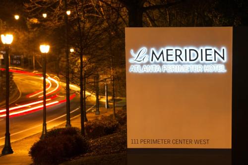 a sign for the l meriden american perimeter hotel at night at Le Meridien Atlanta Perimeter in Atlanta