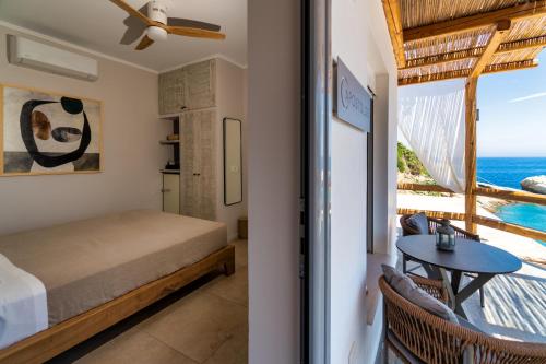 a bedroom with a bed and a view of the ocean at Selene Luxury Rooms in Armenistis