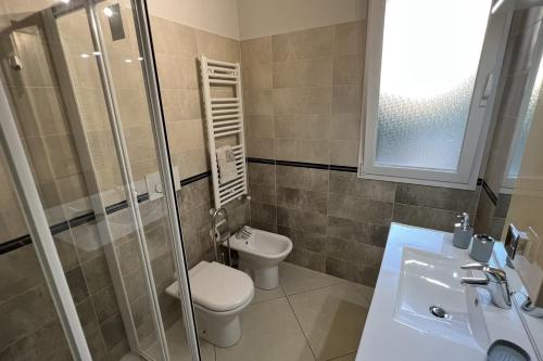 a bathroom with a toilet and a sink and a shower at Plumosus in Arma di Taggia