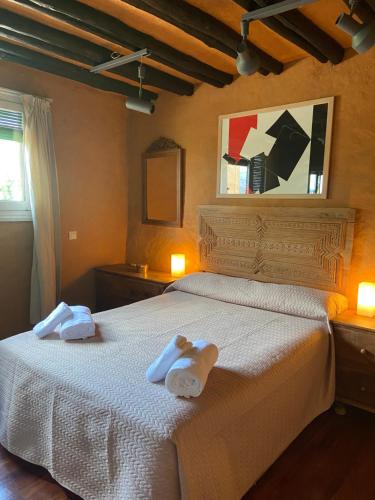 a bedroom with a bed with two towels on it at Finca Valdegrullas in Candeleda