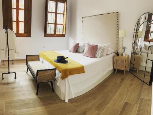 a bedroom with a large bed and a chair at Doña Josefina y Don Simón in Almería