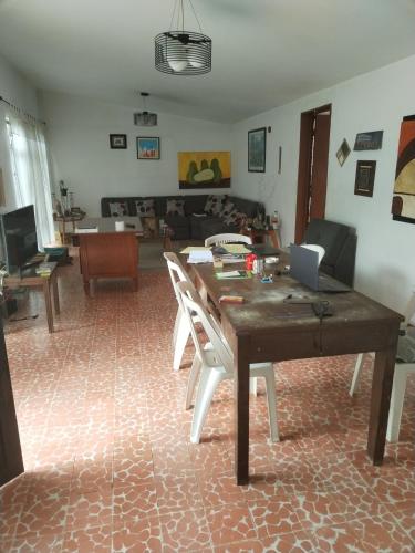 sala de estar con mesa de madera y sillas en Casa CODHE - Sebastián Galicia Carrera en Córdoba