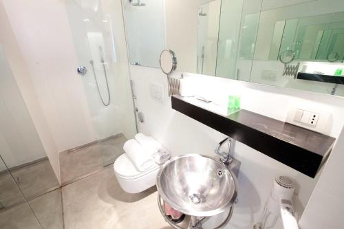 a bathroom with a sink and a toilet and a mirror at Casa Valentina in Mantova
