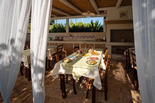a dining room with a table with food on it at TERRA TERRA - Masseria Minunni in Conversano