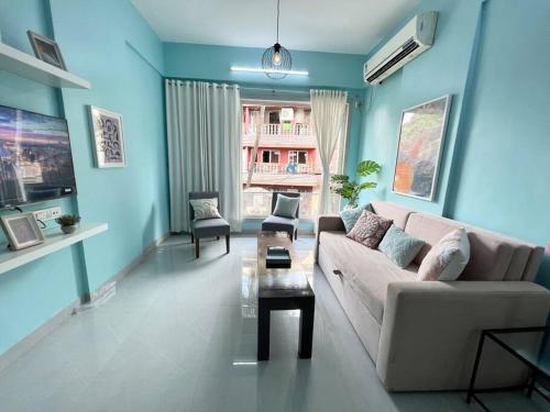 a living room with a couch and a table at Angel Views 101, Chapel Road, Bandra West by Connekt Homes in Mumbai