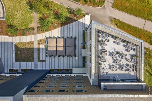 an overhead view of a building with a roof at Dorint Hotel München/Garching in Garching bei München