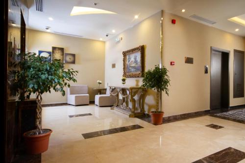 a lobby with potted plants in a building at Cloud City Hotel in Al Baha