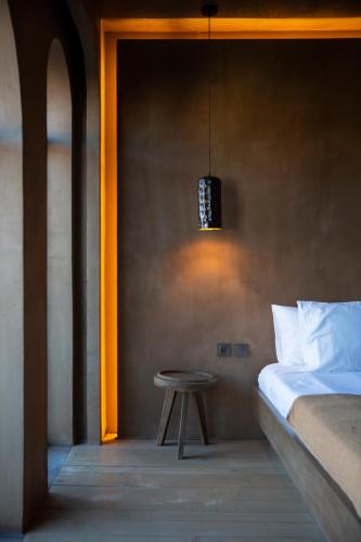 a bedroom with a bed and a table and a lamp at Life Gallery Hotel & Spa in Korçë
