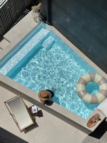 an overhead view of a swimming pool with a lifesaver and a lifeguard at Casas do Patio Country Houses & Nature in Caldas da Felgueira