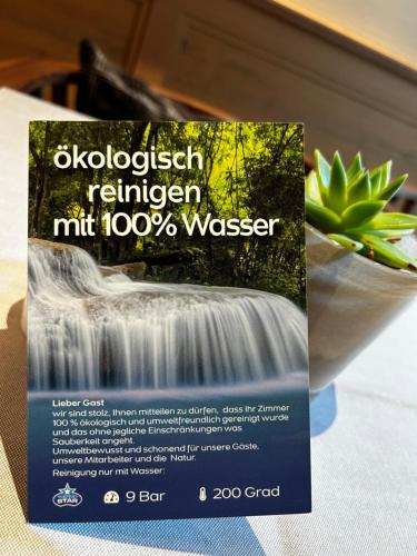 a sign on a table next to a waterfall at Hotel Restaurant Der Engel, Sasbachwalden in Sasbachwalden