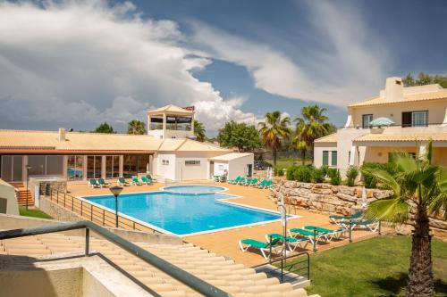 a villa with a swimming pool and a house at Glenridge Resort By Albufeira Rental in Albufeira