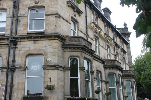 a large stone building with windows and a balcony at The Harrogate Inn - The Inn Collection Group in Harrogate