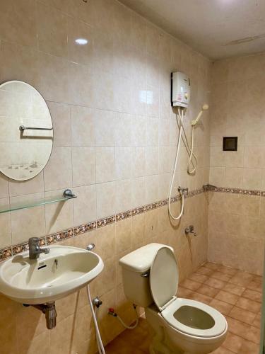 a bathroom with a toilet and a sink at Wantana Mansion Check in before 8 pm in Hat Yai