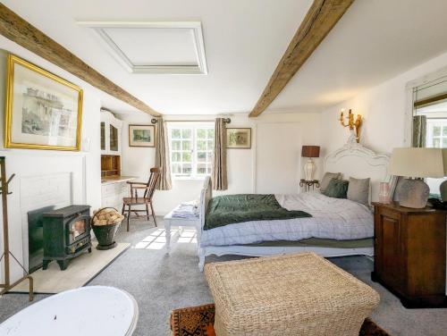a bedroom with a bed and a fireplace at Mabel Cottage, Wickham in Wickham