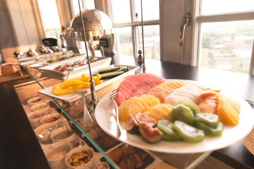 a plate of different types of food on a counter at Boutique Suites Sylt in Kampen am Roten Kliff Re-Opening Mai 2023 in Kampen