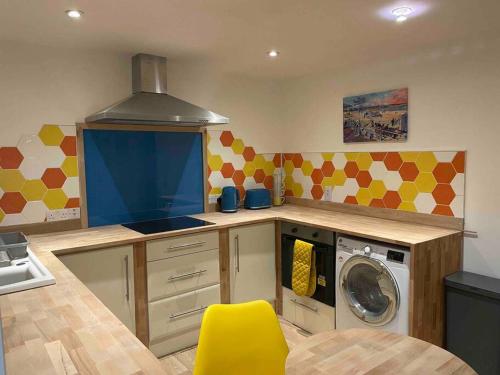 a kitchen with a washer and a washing machine at Poshington willows accessibility friendly in Weymouth