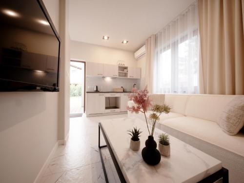 a living room with a white couch and a table at Sweet Dreams Apartment in Zator