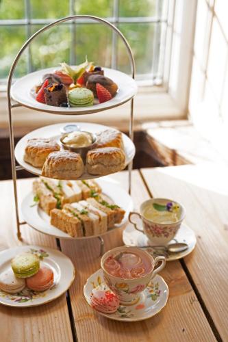two plates of pastries and cups of tea on a table at The Rodney Hotel in Bristol
