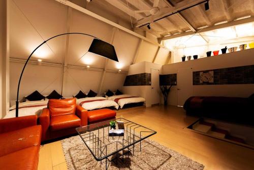 a living room with a couch and a bed at MS STUDIO in Asahikawa