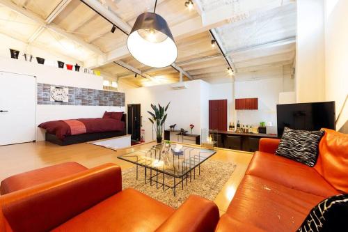 a living room with a couch and a table at MS STUDIO in Asahikawa