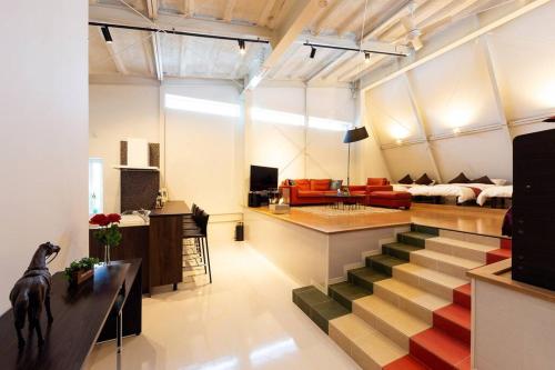 a living room with a staircase leading to a living room at MS STUDIO in Asahikawa