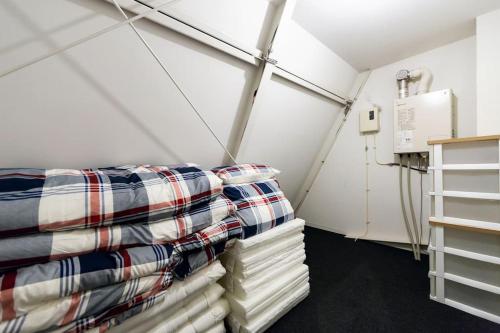 a room with a bed and pillows in it at MS STUDIO in Asahikawa