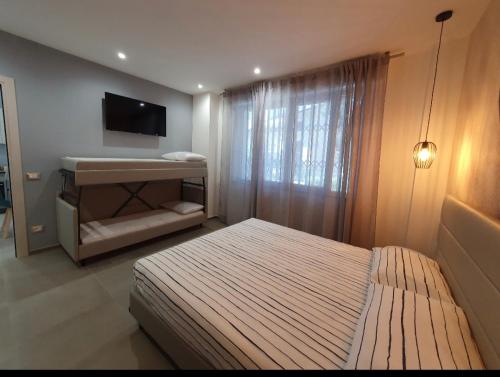 a small bedroom with a bed and a television at Playa degli Angeli Scirocco in Gabicce Mare